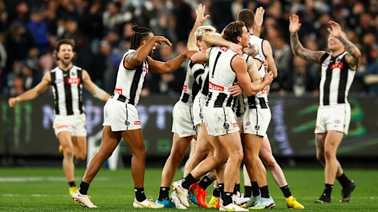 The Magpies celebrate after the final siren in their last-gasp win over Carlton.