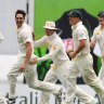 Australia's Mitchell Johnson, left, Michael Clarke, second from left, and David Warner, third from left, celebrate the wicket of England's Stuart Broad, on the fourth day of the series-opening Ashes cricket test between England and Australia at the Gabba in Brisbane, Australia, Sunday, Nov. 24, 2013. (AP Photo/Tertius Pickard)