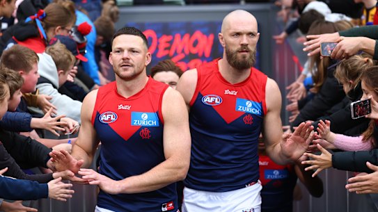Steven May and Max Gawn lead the Demons players out.