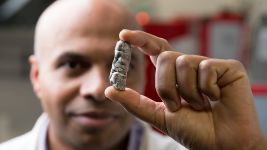 Professor Kondo-Francois Aguey-Zinsou, Chief Scientist at the UNSW's Hydrogen Energy Research Centre, in Sydney. He is holding some of the metal material that his team has developed that can store hydrogen in a solid state - at home or anywhere else.