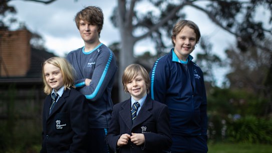 Brothers Henry, Will, Ollie and Charlie model Kingswood College's current and future school uniforms. 