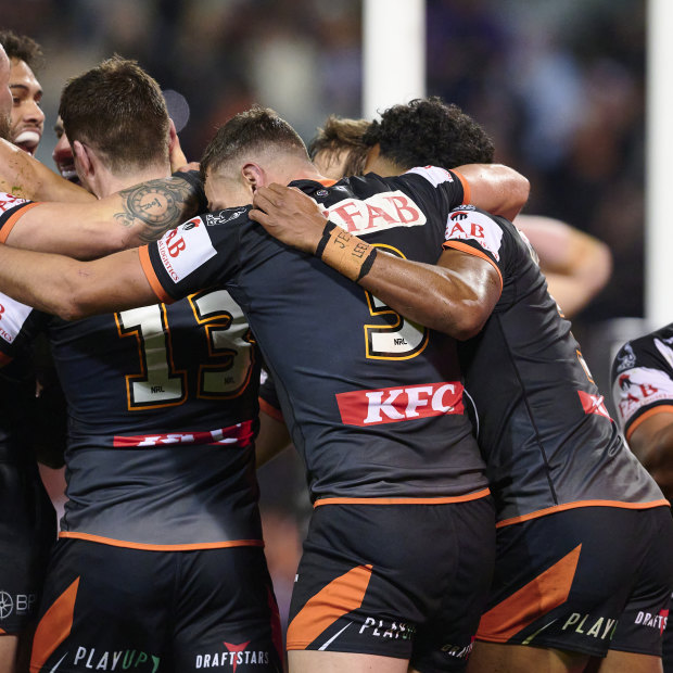 Alex Twal is swarmed by Tigers teammates after scoring the first try of his career against the Melbourne Storm at Leichhardt Oval back in round 16