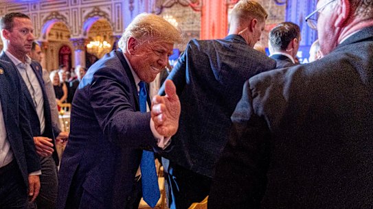Former president Donald Trump greats guests watching the midterm elections at his Mar-a-Lago residence in Florida.