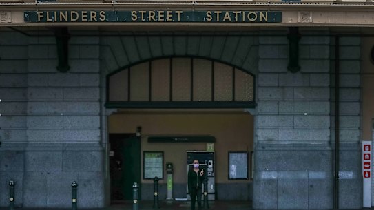 A lone pedestrian at an empty Flinder Street Station.