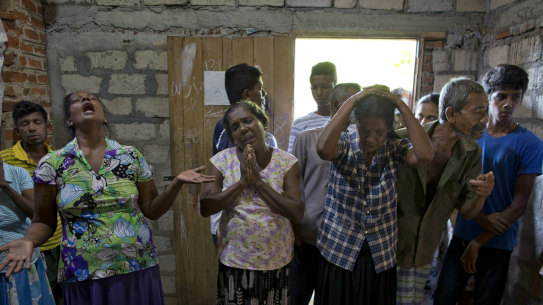 Relatives weep near the coffin with the remains of 12-year Sneha Savindi, who was a victim of Easter Sunday bombing at St Sebastian Church.