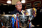 Brisbane coach Chris Fagan with the last three premiership cups. 