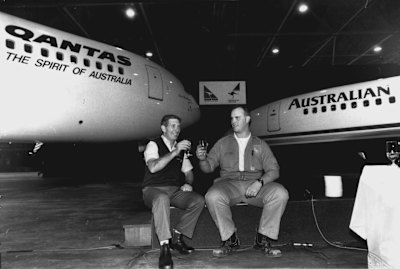 Aust. Airlines Derek Wade, ground handling, and Qantas storeman David Hauser, chat after the official ceremony has been completed... September 14, 1992. 