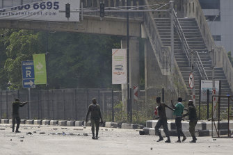 Police detain a protester at the Lekki toll gate in Lagos, Nigeria, on Wednesday.