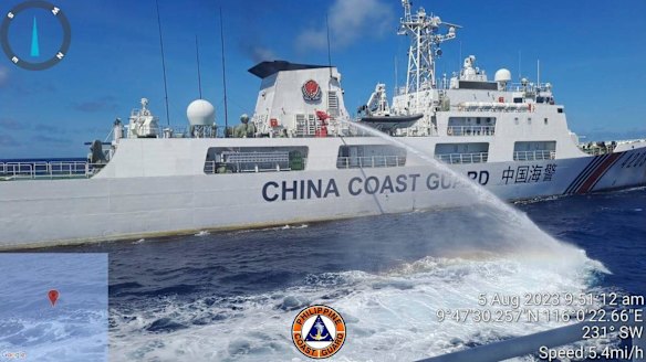 A Chinese Coast Guard ship aims a water cannon at a Philippine military resupply boat near Second Thomas Shoal in the Spratly Islands on August 5.