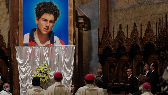 An image of Carlo Acutis is unveiled during his beatification ceremony celebrated by Cardinal Agostino Vallini in the St Francis Basilica, in Assisi, Italy.