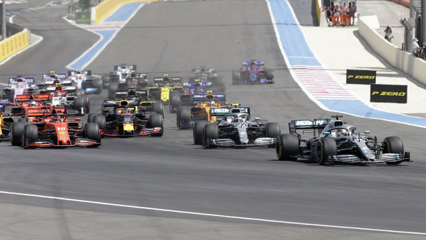 Mercedes driver Lewis Hamilton leads into the first corner ahead of teammate Valtteri Bottas and Ferrari's Charles Leclerc.