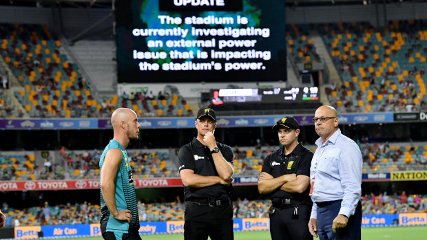 Chris Lynn (left) of the Heat is seen talking to the match officials after play was abandoned on Thursday night.