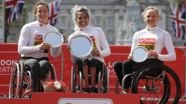 Madison de Rozario of Australia placed first, centre, Tatyana McFadden of USA placed second, left, and Susannah Scaroni of USA placed third.