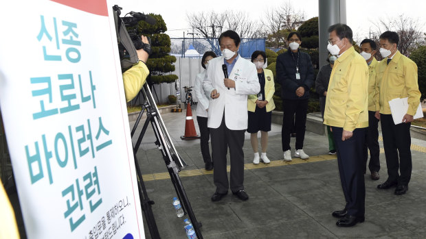 South Korean President Moon Jae-in is briefed by Daegu Medical Centre President You Wansik in Daegu, South Korea.