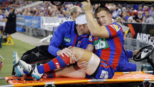 Cruel blow: Slade Griffin faces an agonising wait after being carried from the field on a medi-cab.