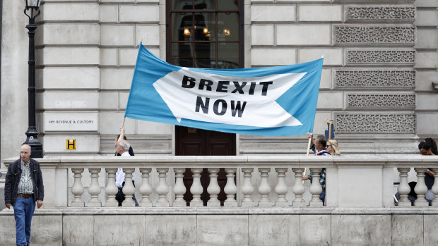 Pro-Brexit demonstrators parade their banner past the Treasury building in London on Thursday.