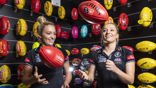 Jess (left) and Sarah Hosking, pictured at the Sherrin factory, will be the first twins to play together in an AFLW grand final.