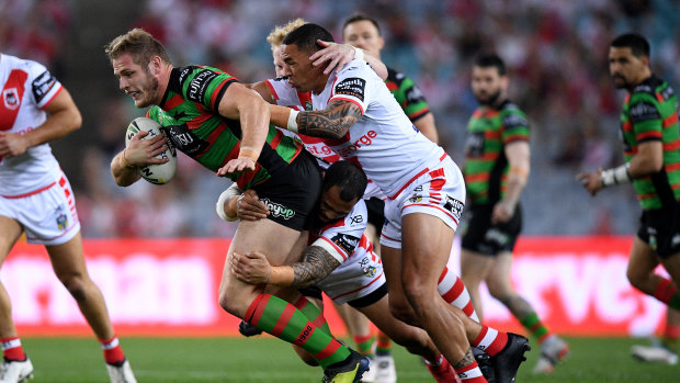 Hard yards: Tom Burgess is tackled by Leeson Ah Mau and Tyson Frizell.