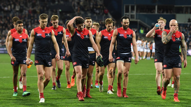 Disappointed: The Demons leave the field after another close loss.