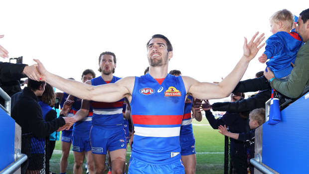Fans' best friends: Easton Wood leads the Bulldogs off the field after their win over the Crows.