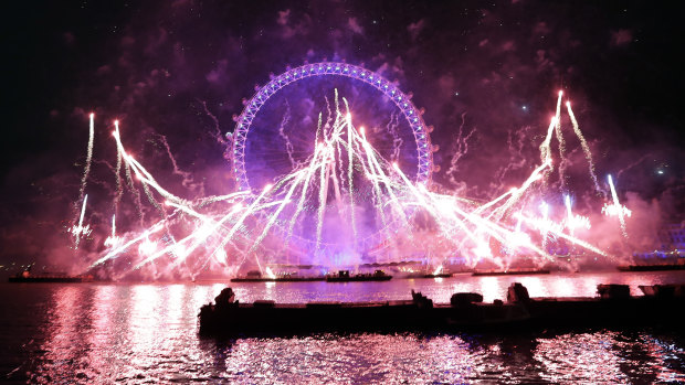 Fireworks explode over the London Eye.