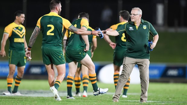 Prime time: Scott Morrison hands out water during the PM's XIII game in Fiji recently.