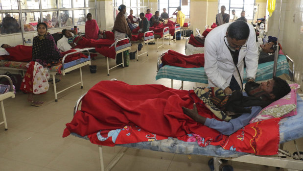 A doctor attends to a victim, who had consumed bootleg liquor, at a hospital in Jorhat in north-eastern state of Assam, India, on Saturday.