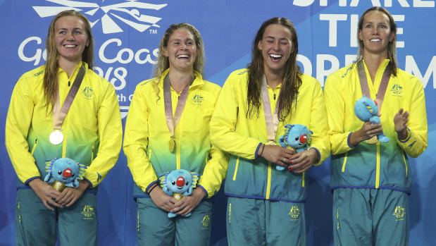 Gold standard: Titmus (left) with Australian teammates after winning 4x200m freestyle gold.