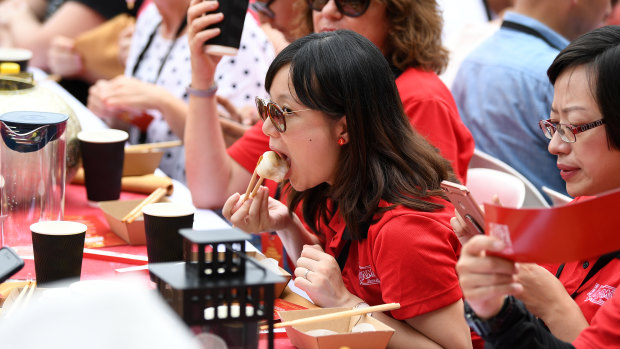 Mouthful: Dumpling fans take part at Darling Harbour.