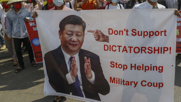 Demonstrators display a picture of Chinese president Xi Jinping, with a message requesting not to support military coup during a protest against the military coup in Mandalay, Myanmar.