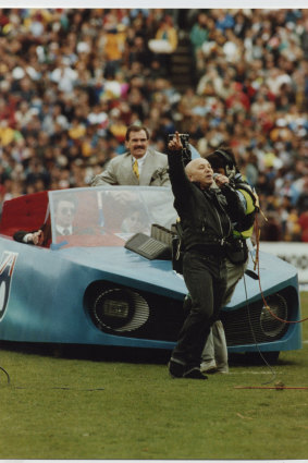 Angry Anderson performs with the Batmobile at the 1991 grand final.