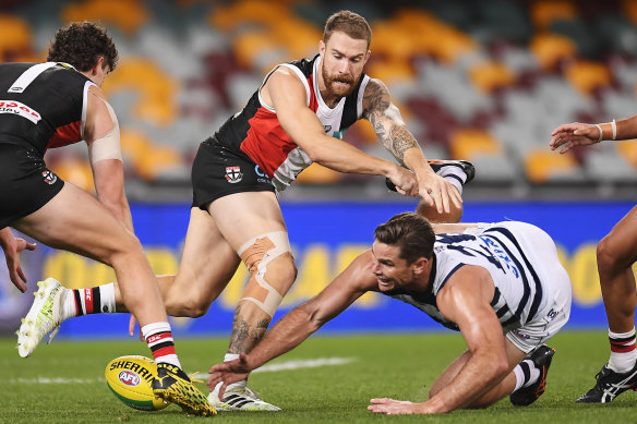 Tom Hawkins, right, competes for the ball. 