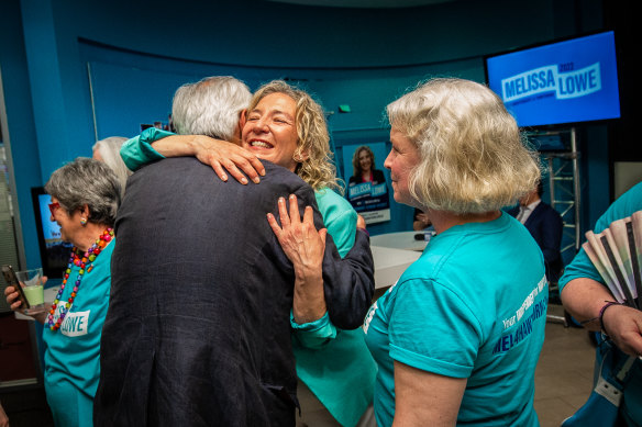 Melissa Lowe hugs a supporter on Saturday night.