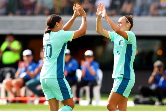 Caitlin Foord celebrates with skipper Sam Kerr.