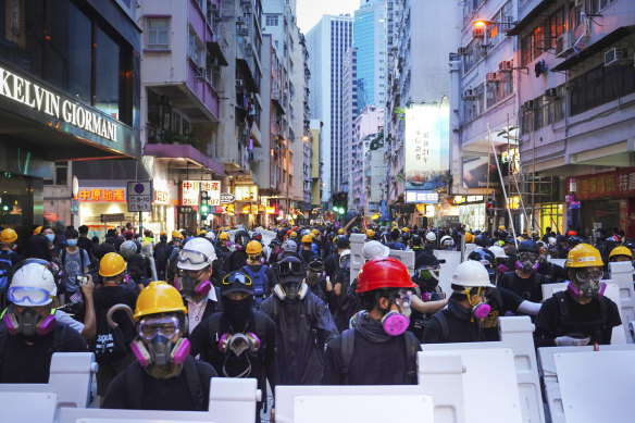 Protesters with protective gear gather in Central, the main business district in Hong Kong, on Sunday.