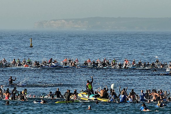 Hundreds of people form a circle during a paddle-out at Bondi Beach to pay tribute to the victims of Sunday night’s massacre.