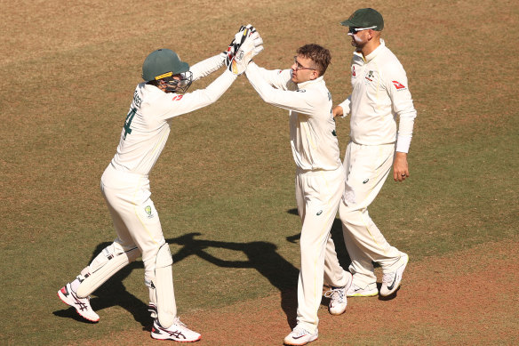 Todd Murphy and Alex Carey celebrate a wicket.