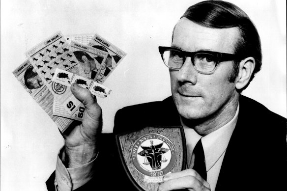 "Lord" John Davies, the first agent General in N.S.W, for the Hutt River Province holds up the province crest and samples of its own money and stamps.