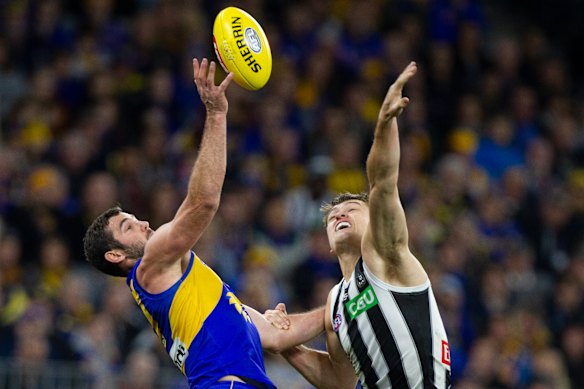 Eagle Jack Darling and Collingwood's Darcy Moore. Moore suffered a hamstring injury in first term.