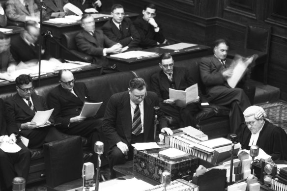 Arthur Fadden, knee raised, delivers the federal budget on  September 26,  1951.