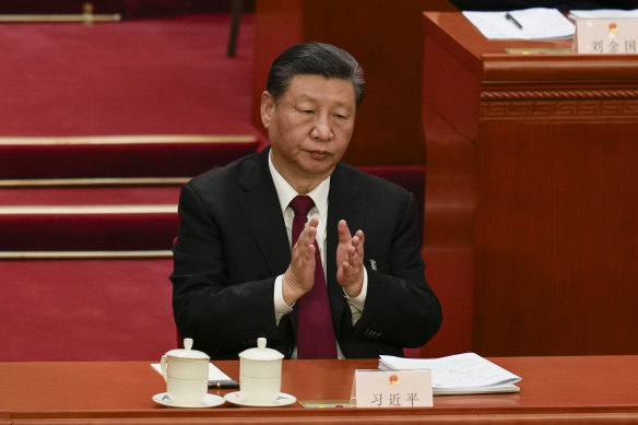 Chinese President Xi Jinping applauds during the opening session of the National People’s Congress. 