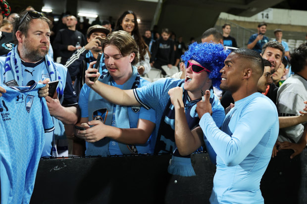 Costa is embraced by fans after his Sydney FC debut last month.