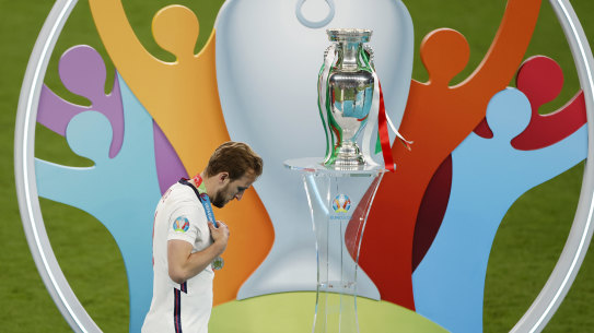 So close, but so far: Harry Kane walks past the trophy after losing the Euro 2020 final on penalties.
