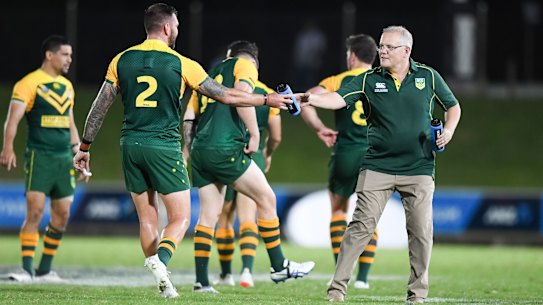 Prime time: Scott Morrison keeps his men hydrated in Suva on Friday night.