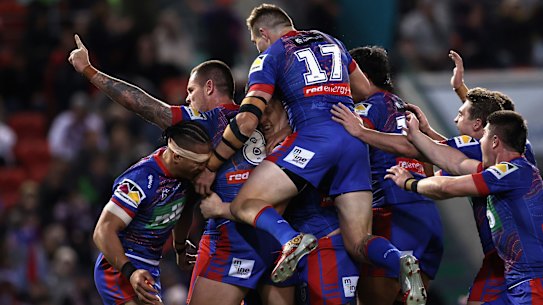 The jubilant Knights celebrate Daniel Saifiti’s try.