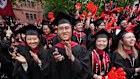 Graduates applaud the decision during commencement ceremonies at Harvard University.
