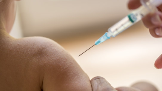 A dctor injecting a young child with a vaccination