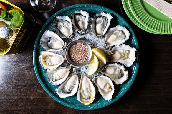 The oysters at The Walrus change often, with the day's selections scratched on glass.