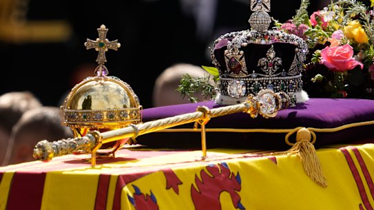 The orb, the sceptre and the crown atop the royal coffin as it leaves Westminster Abbey.