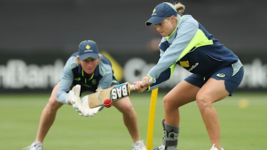 Injured captain Alyssa Healy of Australia and Beth Mooney of Australia practise during warm up before game two in the Women’s Ashes T20 series between Australia and England at Manuka Oval